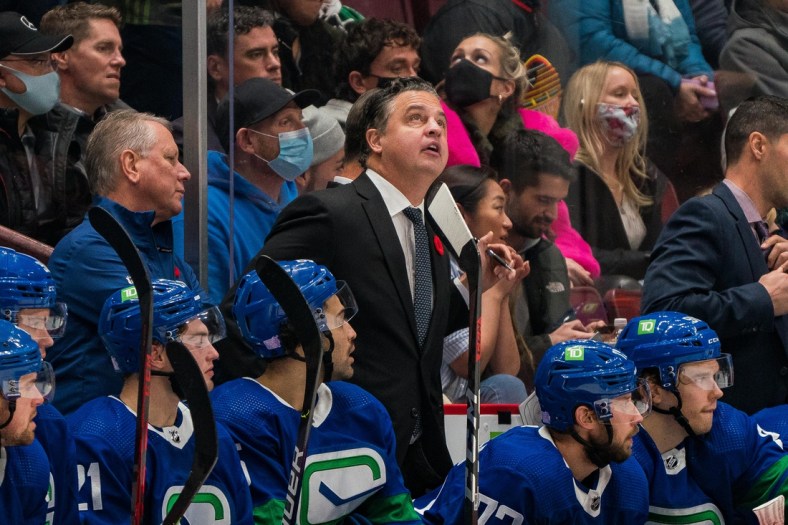 Nov 9, 2021; Vancouver, British Columbia, CAN; Vancouver Canucks head coach Travis Green on the bench against the Anaheim Ducks at Rogers Arena. Mandatory Credit: Bob Frid-USA TODAY Sports