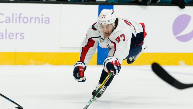 Nov 20, 2021; San Jose, California, USA; Washington Capitals right wing T.J. Oshie (77) dives for the puck against the San Jose Sharks during the fist period at SAP Center at San Jose. Mandatory Credit: John Hefti-USA TODAY Sports