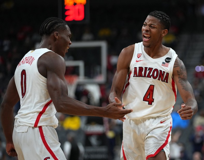Nov 21, 2021; Las Vegas, Nevada, USA; Arizona Wildcats guard Bennedict Mathurin (0) and Arizona Wildcats guard Dalen Terry (4) celebrate after a play against the Michigan Wolverines during the second half at T-Mobile Arena. Mandatory Credit: Stephen R. Sylvanie-USA TODAY Sports