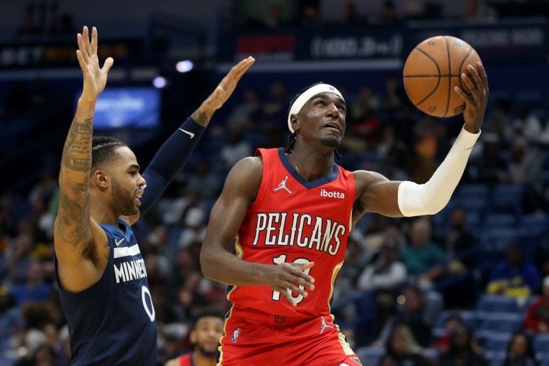 Nov 22, 2021; New Orleans, Louisiana, USA; New Orleans Pelicans guard Kira Lewis Jr. (13) shoots while defended by Minnesota Timberwolves guard D'Angelo Russell (0) in the second half at the Smoothie King Center. Mandatory Credit: Chuck Cook-USA TODAY Sports