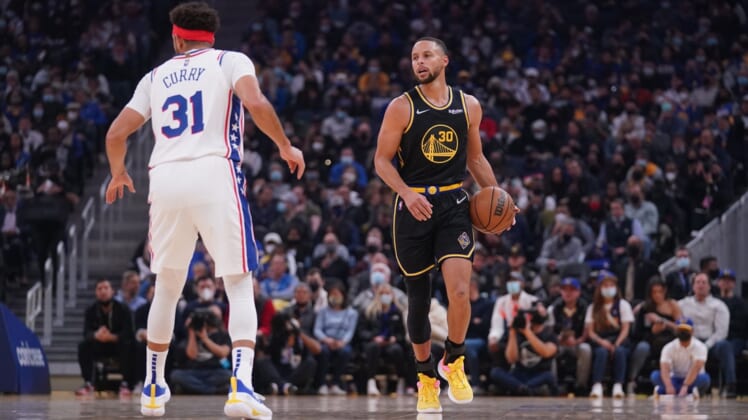 Nov 24, 2021; San Francisco, California, USA; Golden State Warriors guard Stephen Curry (30) dribbles the ball next to Philadelphia 76ers guard Seth Curry (31) in the first quarter at the Chase Center. Mandatory Credit: Cary Edmondson-USA TODAY Sports