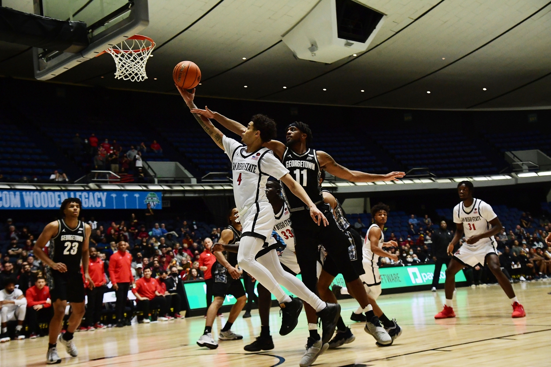 Nov 25, 2021; Anaheim, CA, USA; San Diego State Aztecs guard Trey Pulliam (4) moves to the basket ahead of Georgetown Hoyas guard Kaiden Rice (11) during the second half of the Wooden Legacy at Anaheim Arena. Mandatory Credit: Gary A. Vasquez-USA TODAY Sports