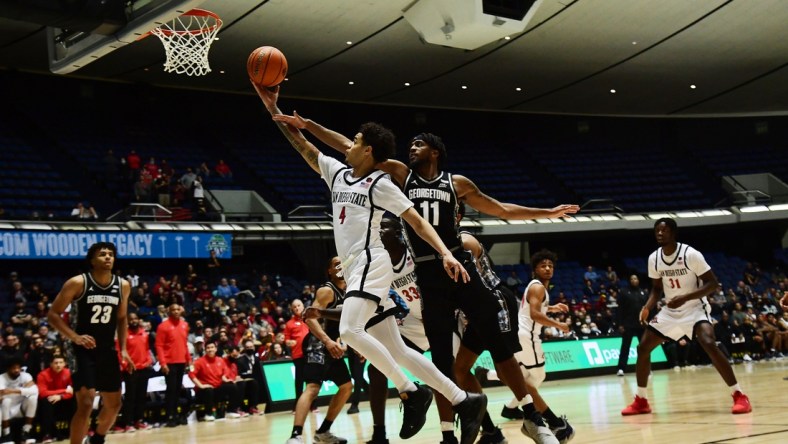 Nov 25, 2021; Anaheim, CA, USA; San Diego State Aztecs guard Trey Pulliam (4) moves to the basket ahead of Georgetown Hoyas guard Kaiden Rice (11) during the second half of the Wooden Legacy at Anaheim Arena. Mandatory Credit: Gary A. Vasquez-USA TODAY Sports