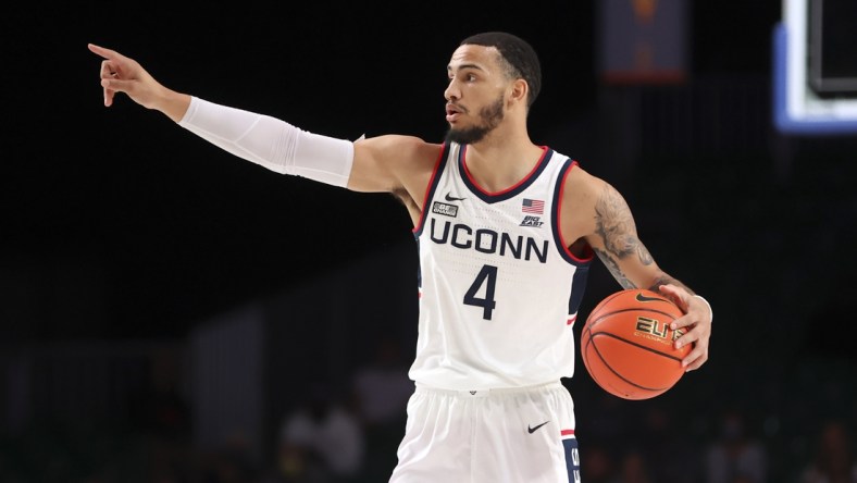 Nov 26, 2021; Nassau, BHS;  Connecticut Huskies guard Tyrese Martin (4) dribbles during the first half against the Virginia Commonwealth Rams in the 2021 Battle 4 Atlantis at Imperial Arena. Mandatory Credit: Kevin Jairaj-USA TODAY Sports