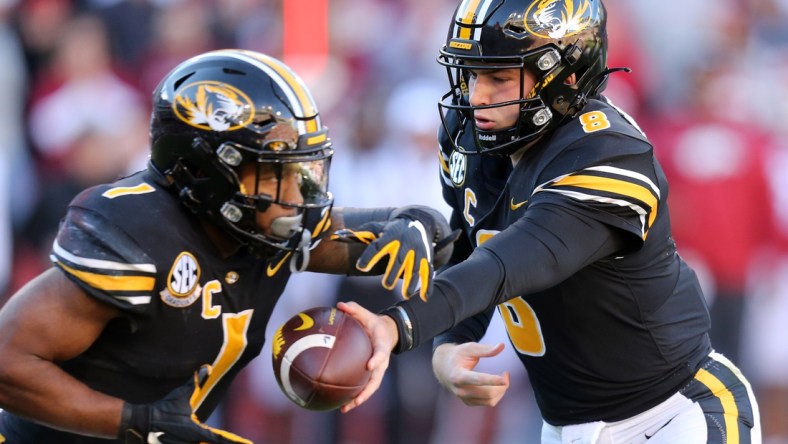 Nov 26, 2021; Fayetteville, Arkansas, USA; Missouri Tigers quarterback Connor Bazelak (8) hands the ball off to running back Tyler Badie (1) during the first quarter against the Arkansas Razorbacks at Donald W. Reynolds Razorbacks Stadium. Mandatory Credit: Nelson Chenault-USA TODAY Sports