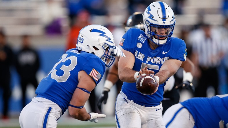 Nov 26, 2021; Colorado Springs, Colorado, USA; Air Force Falcons quarterback Jensen Jones (5) hands the ball off to outside linebacker Jet Harris (33) in the fourth quarter against the UNLV Rebels at Falcon Stadium. Mandatory Credit: Isaiah J. Downing-USA TODAY Sports