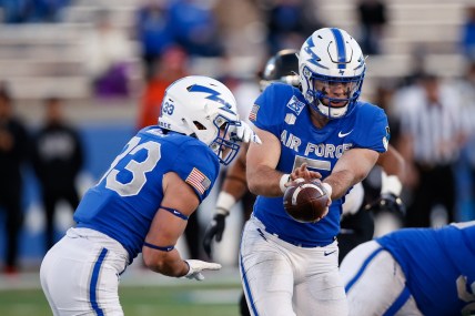 Nov 26, 2021; Colorado Springs, Colorado, USA; Air Force Falcons quarterback Jensen Jones (5) hands the ball off to outside linebacker Jet Harris (33) in the fourth quarter against the UNLV Rebels at Falcon Stadium. Mandatory Credit: Isaiah J. Downing-USA TODAY Sports