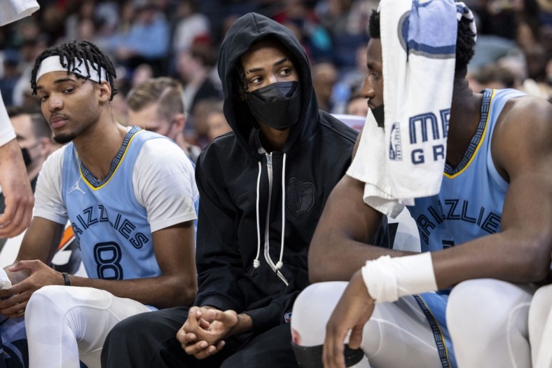 Nov 26, 2021; Memphis, Tennessee, USA; Memphis Grizzlies guard Ja Morant (center) sits on the sidelines after an injury forced him out of the game in the second half of a game against the Atlanta Hawks at FedExForum. Mandatory Credit: Vasha Hunt-USA TODAY Sports