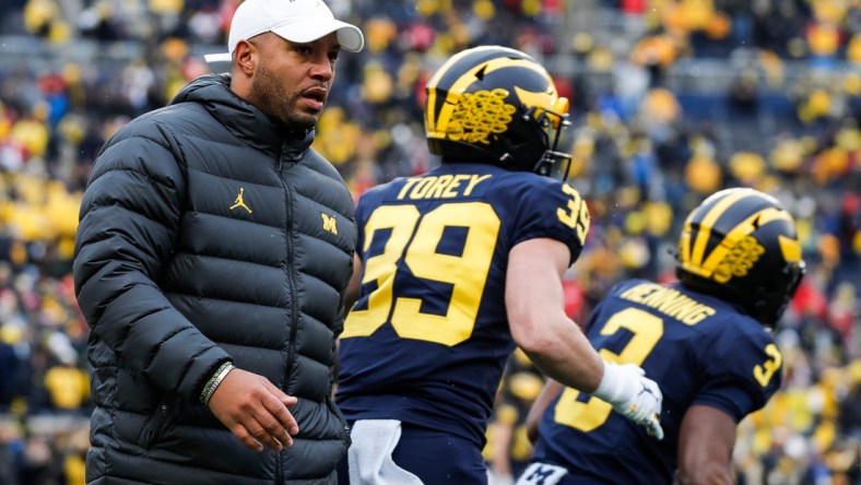 Michigan offensive coordinator Josh Gattis watches warmups before the Ohio State game at Michigan Stadium in Ann Arbor on Saturday, Nov. 27, 2021.