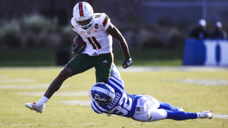 Nov 27, 2021; Durham, North Carolina, USA; Miami Hurricanes wide receiver Charleston Rambo (11) with the ball while Duke Blue Devils safety Jalen Alexander (32) tries to tackle him during the second half of the game against the Miami Hurricanes at Wallace Wade Stadium. at Wallace Wade Stadium. Mandatory Credit: Jaylynn Nash-USA TODAY Sports