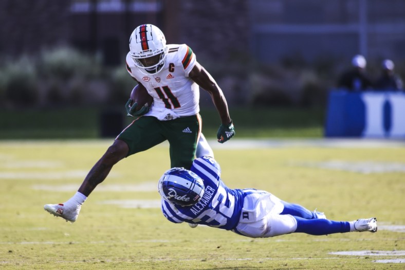 Nov 27, 2021; Durham, North Carolina, USA; Miami Hurricanes wide receiver Charleston Rambo (11) with the ball while Duke Blue Devils safety Jalen Alexander (32) tries to tackle him during the second half of the game against the Miami Hurricanes at Wallace Wade Stadium. at Wallace Wade Stadium. Mandatory Credit: Jaylynn Nash-USA TODAY Sports