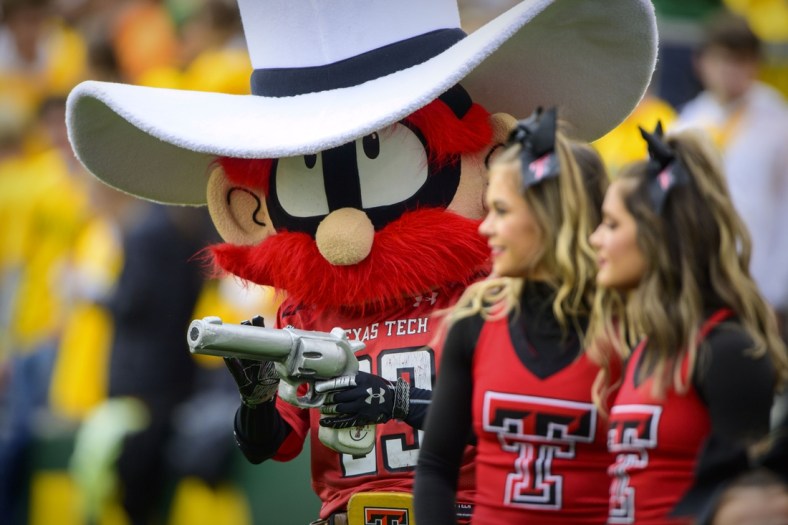 Nov 27, 2021; Waco, Texas, USA; The Texas Tech Red Raiders mascot walks the sidelines with the cheerleaders during the first half of the game between the Baylor Bears and the Texas Tech Red Raiders at McLane Stadium. Mandatory Credit: Jerome Miron-USA TODAY Sports