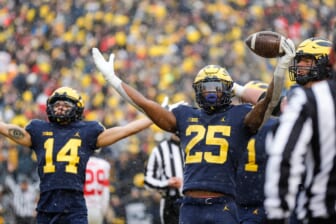 Michigan running back Hassan Haskins (25) celebrates  scoring a touchdown against Ohio State during the second half at Michigan Stadium in Ann Arbor on Saturday, Nov. 27, 2021.michigan happy