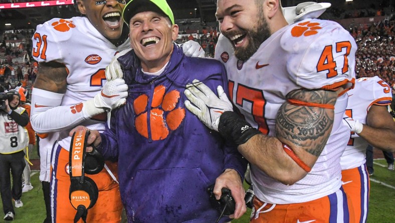 Clemson defensive coordinator Brent Venables is dunked with sports drink by linebacker James Skalski (47) and linebacker Baylon Spector (10) with corner back Mario Goodrich (31) after the game at Williams Brice Stadium in Columbia, South Carolina Saturday, November 27, 2021.  Clemson won 30-0.

Clemson U Of Sc Football In Columbia