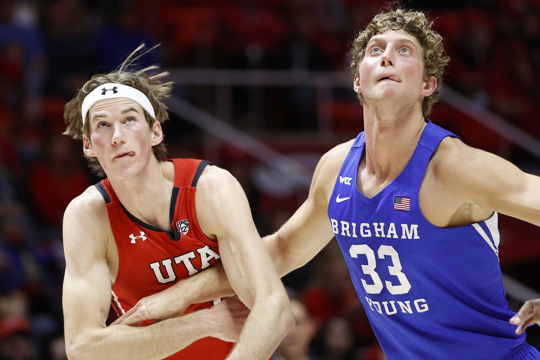 Nov 27, 2021; Salt Lake City, Utah, USA; Utah Utes center Branden Carlson (35) and Brigham Young Cougars forward Caleb Lohner (33) battle in the first half at Jon M. Huntsman Center. Mandatory Credit: Jeffrey Swinger-USA TODAY Sports