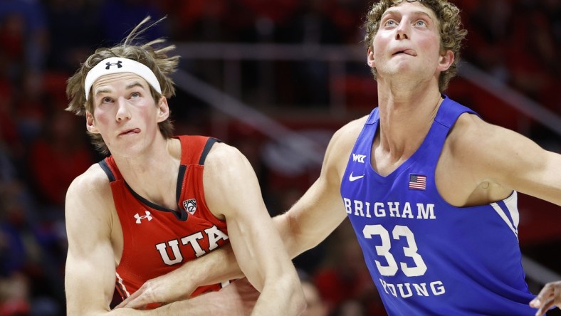 Nov 27, 2021; Salt Lake City, Utah, USA; Utah Utes center Branden Carlson (35) and Brigham Young Cougars forward Caleb Lohner (33) battle in the first half at Jon M. Huntsman Center. Mandatory Credit: Jeffrey Swinger-USA TODAY Sports