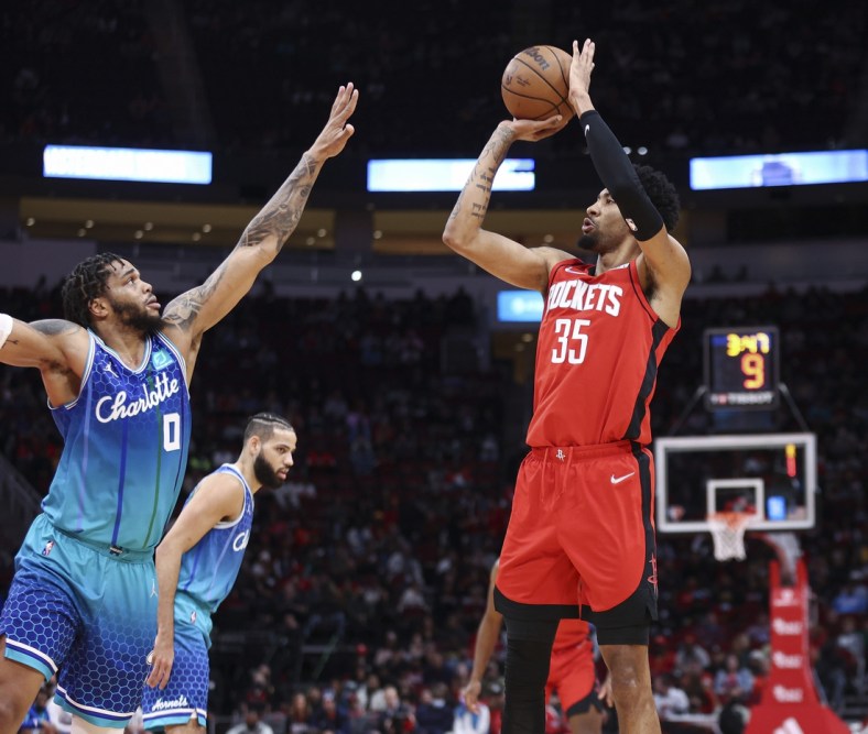Nov 27, 2021; Houston, Texas, USA; Houston Rockets center Christian Wood (35) shoots the ball as Charlotte Hornets forward Miles Bridges (0) defends during the first quarter at Toyota Center. Mandatory Credit: Troy Taormina-USA TODAY Sports
