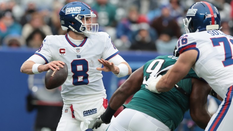 Nov 28, 2021; East Rutherford, New Jersey, USA; New York Giants quarterback Daniel Jones (8) throws the ball against the Philadelphia Eagles during the first quarter at MetLife Stadium. Mandatory Credit: Vincent Carchietta-USA TODAY Sports