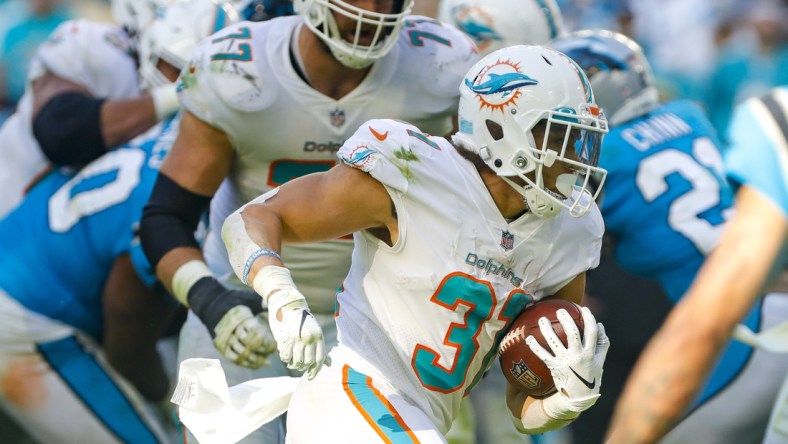 Nov 28, 2021; Miami Gardens, Florida, USA; Miami Dolphins running back Phillip Lindsay (31) runs with the football against the Carolina Panthers during the fourth quarter at Hard Rock Stadium. Mandatory Credit: Sam Navarro-USA TODAY Sports