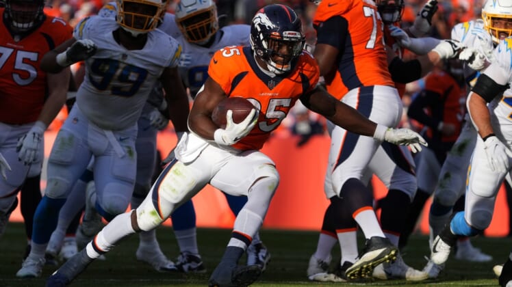 Nov 28, 2021; Denver, Colorado, USA; Denver Broncos running back Melvin Gordon (25) carries the ball in the first half against the Los Angeles Chargers at Empower Field at Mile High. Mandatory Credit: Ron Chenoy-USA TODAY Sports