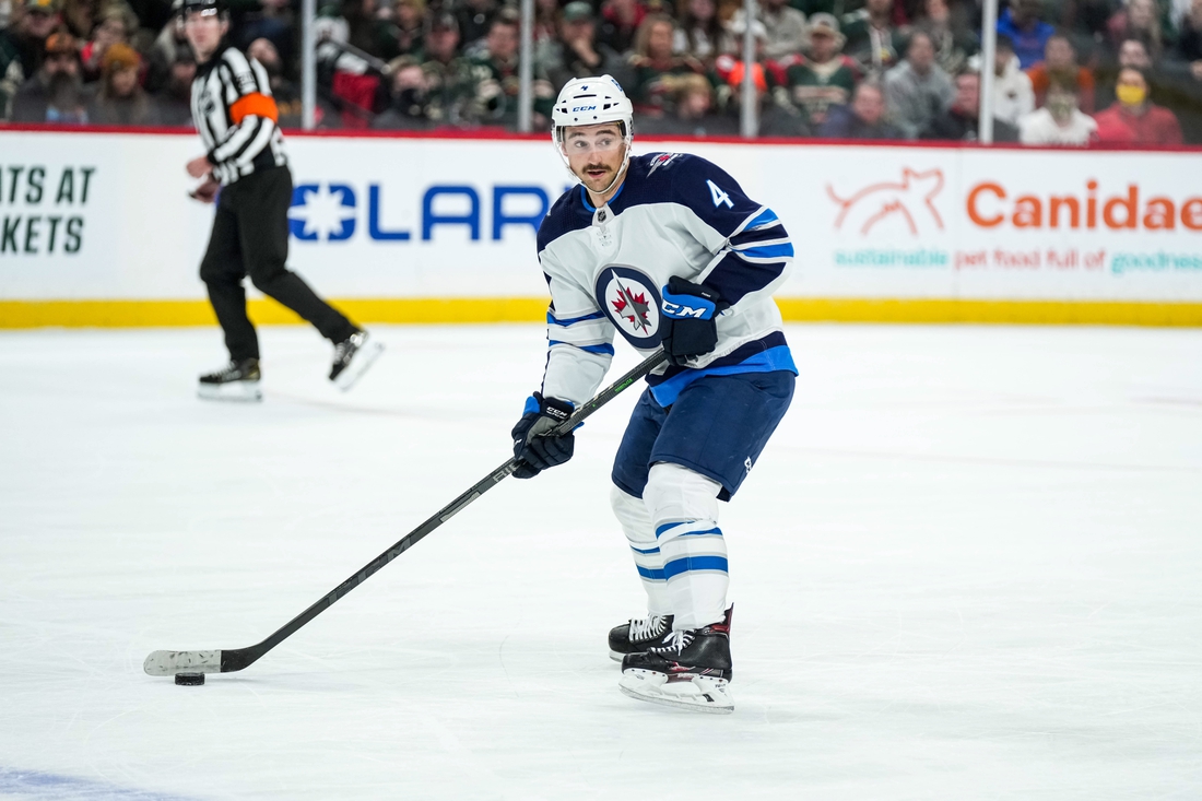 Nov 26, 2021; Saint Paul, Minnesota, USA; Winnipeg Jets defenseman Neal Pionk (4) during a game between the Minnesota Wild and Winnipeg Jets at Xcel Energy Center. Mandatory Credit: Brace Hemmelgarn-USA TODAY Sports