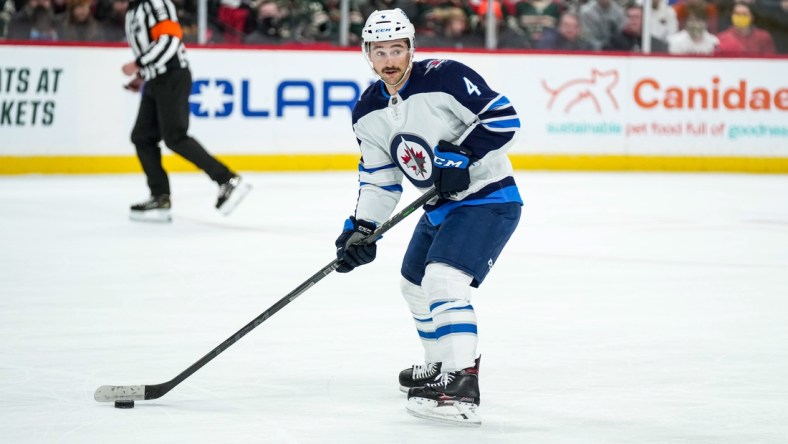 Nov 26, 2021; Saint Paul, Minnesota, USA; Winnipeg Jets defenseman Neal Pionk (4) during a game between the Minnesota Wild and Winnipeg Jets at Xcel Energy Center. Mandatory Credit: Brace Hemmelgarn-USA TODAY Sports