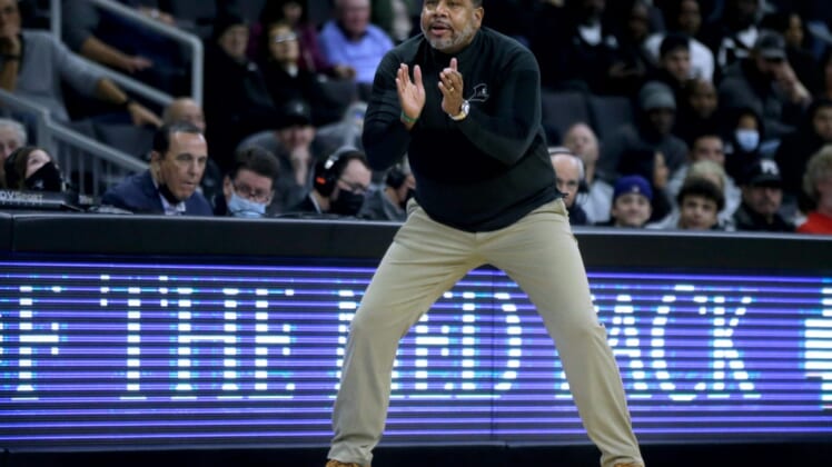 Providence College men's basketball coach Ed Cooley gestures to his players from the sideline during the game against the University of New Hampshire Nov. 18 at the Dunkin' Donuts Center.Cooley