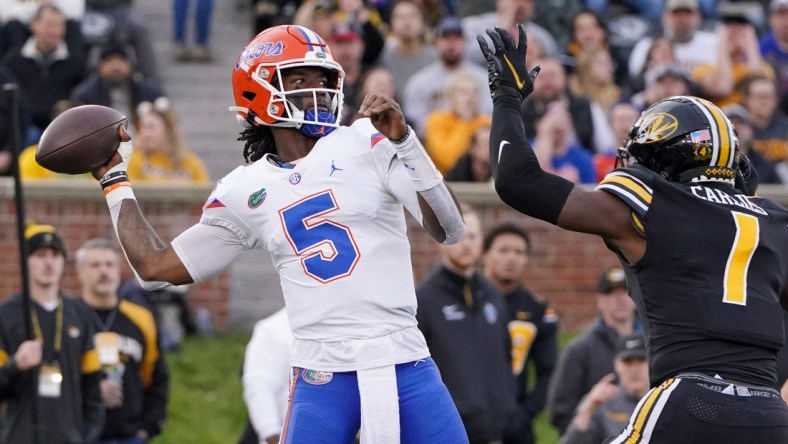 Nov 20, 2021; Columbia, Missouri, USA; Florida Gators quarterback Emory Jones (5) throws a pass as Missouri Tigers defensive back Jaylon Carlies (1) defends during the game at Faurot Field at Memorial Stadium. Mandatory Credit: Denny Medley-USA TODAY Sports