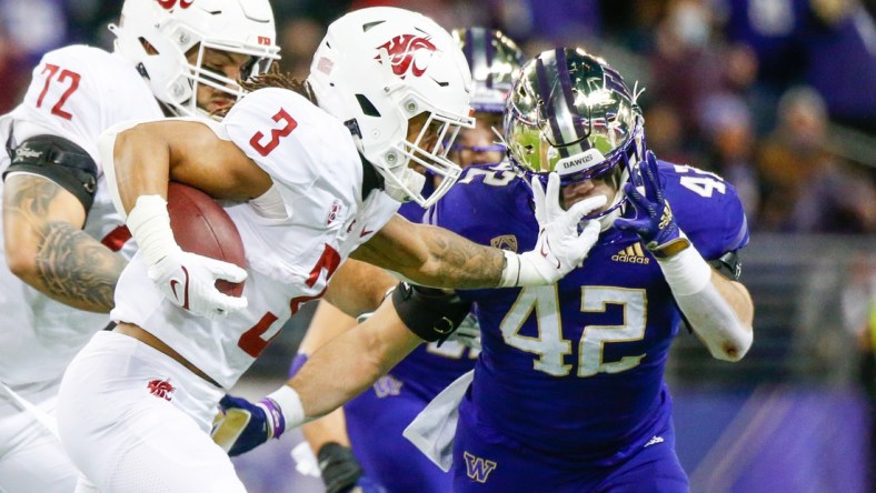 Nov 26, 2021; Seattle, Washington, USA; Washington State Cougars running back Deon McIntosh (3) and Washington Huskies linebacker Carson Bruener (42) during the first quarter at Alaska Airlines Field at Husky Stadium. Mandatory Credit: Joe Nicholson-USA TODAY Sports