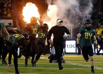 Head Coach Chip Kelly, center, and the team take the field for the first Pac-12 Championship game at Autzen in 2011.

Eug 113021 Pac12 Champs 01