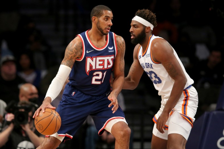 Nov 30, 2021; Brooklyn, New York, USA; Brooklyn Nets forward LaMarcus Aldridge (21) controls the ball against New York Knicks center Mitchell Robinson (23) during the first quarter at Barclays Center. Mandatory Credit: Brad Penner-USA TODAY Sports