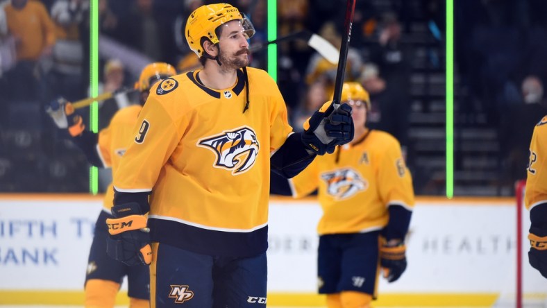 Nov 30, 2021; Nashville, Tennessee, USA; Nashville Predators left wing Filip Forsberg (9) celebrates after a four goal game in the 6-0 win over the Columbus Blue Jackets at Bridgestone Arena. Mandatory Credit: Christopher Hanewinckel-USA TODAY Sports