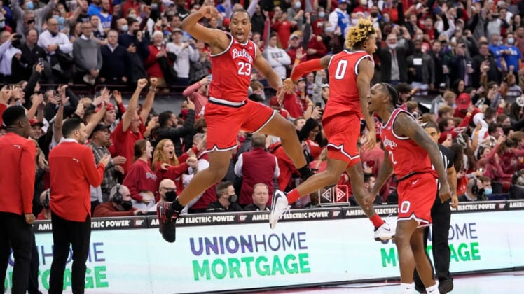 Ohio State Buckeyes forward Zed Key (23) celebrates with guard Meechie Johnson Jr. (0) and guard Cedric Russell (2) following their 71-66 win over the Duke Blue Devils in the NCAA men's basketball game at Value City Arena in Columbus on Wednesday, Dec. 1, 2021.Duke At Ohio State Big Ten Acc Challenge