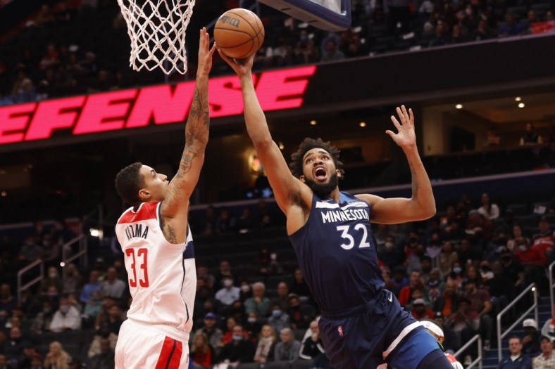 Dec 1, 2021; Washington, District of Columbia, USA; Minnesota Timberwolves center Karl-Anthony Towns (32) shoots the ball as Washington Wizards forward Kyle Kuzma (33) defends during the first quarter at Capital One Arena. Mandatory Credit: Geoff Burke-USA TODAY Sports