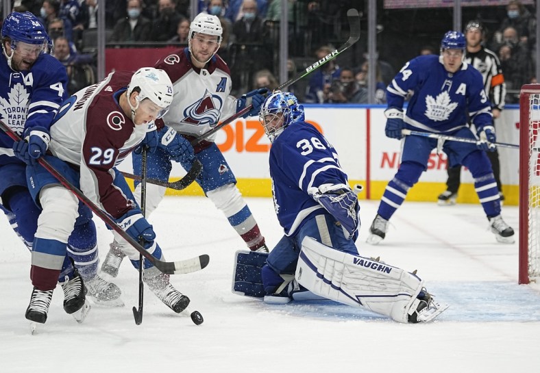 Dec 1, 2021; Toronto, Ontario, CAN; Colorado Avalanche forward Nathan MacKinnon (29) tries to get a shot off against Toronto Maple Leafs goaltender Jack Campbell (36) as Toronto Maple Leafs defenseman Morgan Rielly (44) helps out during the first period at Scotiabank Arena. Mandatory Credit: John E. Sokolowski-USA TODAY Sports