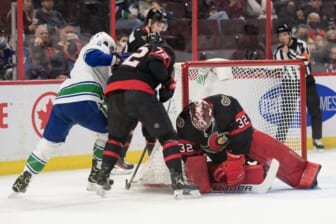 Dec 1, 2021; Ottawa, Ontario, CAN; Ottawa Senators goalie Filip Gustavsson (32) makes a save in front of Vancouver Canucks center J.T. Miller (9) in the first period at the Canadian Tire Centre. Mandatory Credit: Marc DesRosiers-USA TODAY Sports