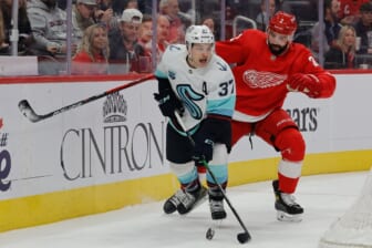 Dec 1, 2021; Detroit, Michigan, USA;  Seattle Kraken center Yanni Gourde (37) skates with the puck chased by Detroit Red Wings defenseman Nick Leddy (2) in the first period at Little Caesars Arena. Mandatory Credit: Rick Osentoski-USA TODAY Sports