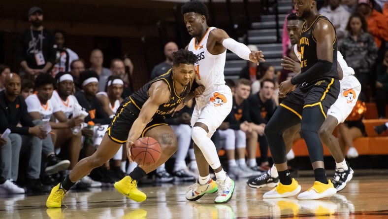 Dec 1, 2021; Stillwater, Oklahoma, USA; Wichita State Shockers guard Tyson Etienne (1) fights for position against Oklahoma State Cowboys guard Bryce Williams (14) during the first half at Gallagher-Iba Arena. Mandatory Credit: Rob Ferguson-USA TODAY Sports