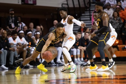 Dec 1, 2021; Stillwater, Oklahoma, USA; Wichita State Shockers guard Tyson Etienne (1) fights for position against Oklahoma State Cowboys guard Bryce Williams (14) during the first half at Gallagher-Iba Arena. Mandatory Credit: Rob Ferguson-USA TODAY Sports
