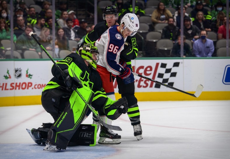 Dec 2, 2021; Dallas, Texas, USA; Dallas Stars defenseman Ryan Suter (20) and goaltender Jake Oettinger (29) defend against Columbus Blue Jackets center Jack Roslovic (96) during the first period at the  American Airlines Center. Mandatory Credit: Jerome Miron-USA TODAY Sports