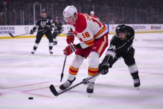 Dec 2, 2021; Los Angeles, California, USA; Calgary Flames defenseman Nikita Zadorov (16) and LA Kings left wing Phillip Danault (24) battle for the puck in the first period at Staples Center. Mandatory Credit: Kirby Lee-USA TODAY Sports