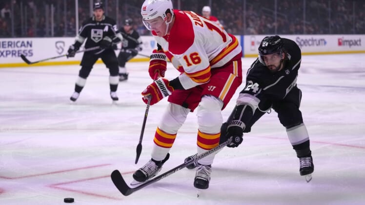 Dec 2, 2021; Los Angeles, California, USA; Calgary Flames defenseman Nikita Zadorov (16) and LA Kings left wing Phillip Danault (24) battle for the puck in the first period at Staples Center. Mandatory Credit: Kirby Lee-USA TODAY Sports