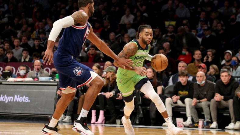 Dec 3, 2021; Brooklyn, New York, USA; Minnesota Timberwolves guard D'Angelo Russell (0) drives to the basket against Brooklyn Nets center LaMarcus Aldridge (21) during the first quarter at Barclays Center. Mandatory Credit: Brad Penner-USA TODAY Sports