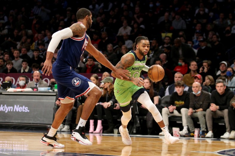 Dec 3, 2021; Brooklyn, New York, USA; Minnesota Timberwolves guard D'Angelo Russell (0) drives to the basket against Brooklyn Nets center LaMarcus Aldridge (21) during the first quarter at Barclays Center. Mandatory Credit: Brad Penner-USA TODAY Sports
