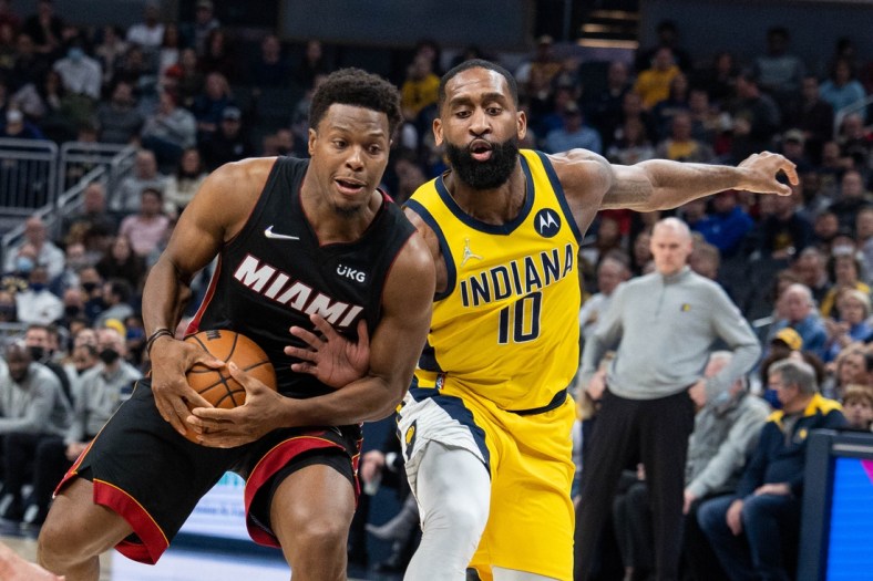 Dec 3, 2021; Indianapolis, Indiana, USA; Miami Heat guard Kyle Lowry (7) is fouled by Indiana Pacers guard Brad Wanamaker (10) in the first half at Gainbridge Fieldhouse. Mandatory Credit: Trevor Ruszkowski-USA TODAY Sports
