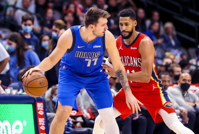 Dec 3, 2021; Dallas, Texas, USA;  Dallas Mavericks guard Luka Doncic (77) controls the ball as New Orleans Pelicans forward Garrett Temple (41) defends during the first quarter at American Airlines Center. Mandatory Credit: Kevin Jairaj-USA TODAY Sports