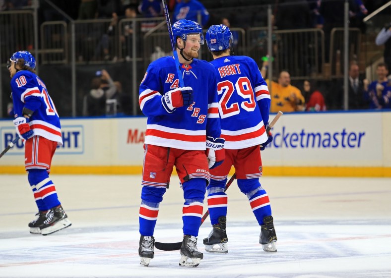 Dec 3, 2021; New York, New York, USA; New York Rangers left wing Alexis Lafreni  re (13) smiles as his teammates celebrate a 1-0 win against the San Jose Sharks at Madison Square Garden. Mandatory Credit: Danny Wild-USA TODAY Sports
