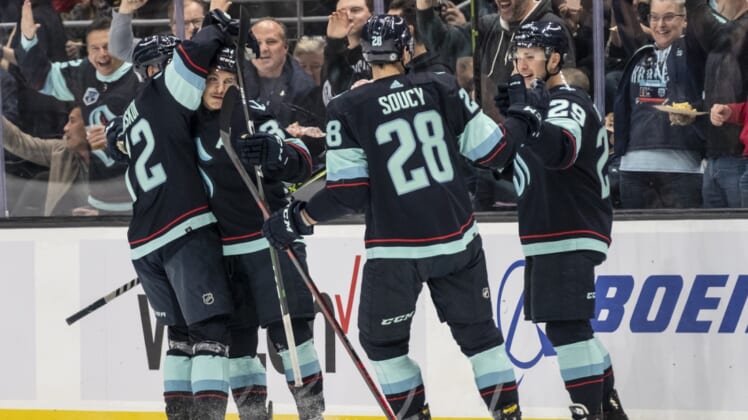 Dec 3, 2021; Seattle, Washington, USA;  Seattle Kraken (L-R) center Mason Appleton (22) and center Yanni Gourde (37) and defenseman Carson Soucy (28) and defenseman Vince Dunn (29) celebrate a goal during the first period against the Edmonton Oilers at Climate Pledge Arena. Mandatory Credit: Stephen Brashear-USA TODAY Sports