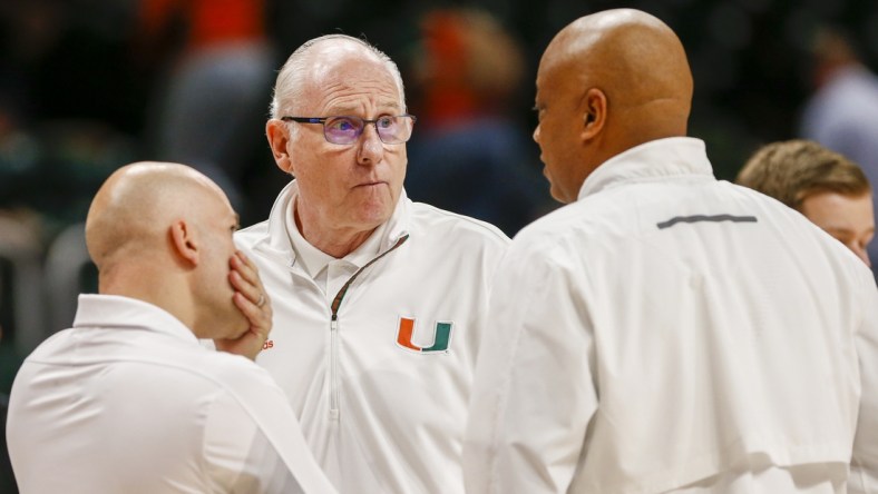 Dec 4, 2021; Coral Gables, Florida, USA; Miami Hurricanes head coach Jim Larranaga talks to his coaching staff during the game against Clemson Tigers at Watsco Center. Mandatory Credit: Sam Navarro-USA TODAY Sports