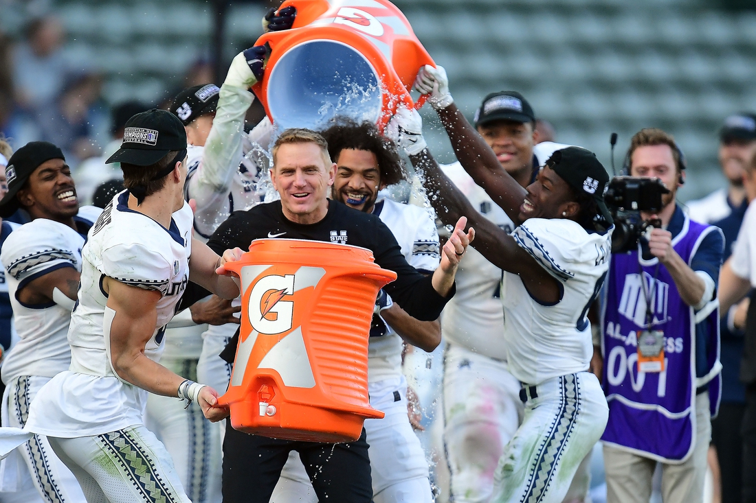 Dec 4, 2021; Carson, CA, USA; Utah State Aggies players pour gatorade on Utah State Aggies head coach Blake Anderson in celebration of the victory against San Diego State Aztecs in the Mountain West Conference championship game at Dignity Health Sports Park. Mandatory Credit: Gary A. Vasquez-USA TODAY Sports